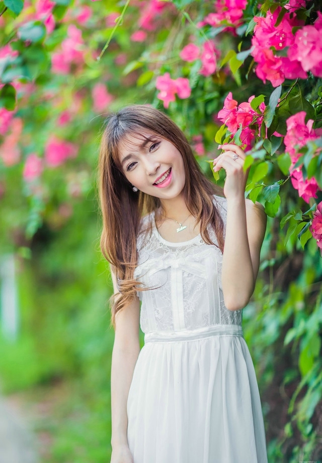 公园内的花恋美女蕾丝裙梨涡甜笑美艳十足