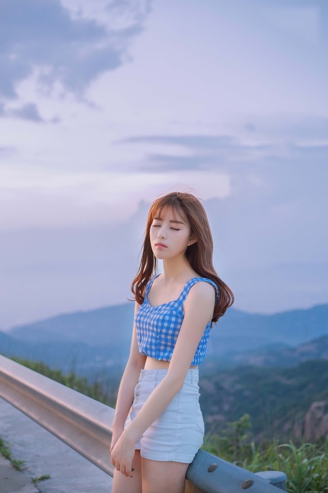 公路上的西瓜少女蓝白格子衫热裤装清凉解暑