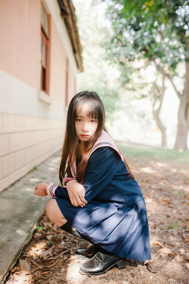 水手服少女俏丽可爱户外骑车满面笑容